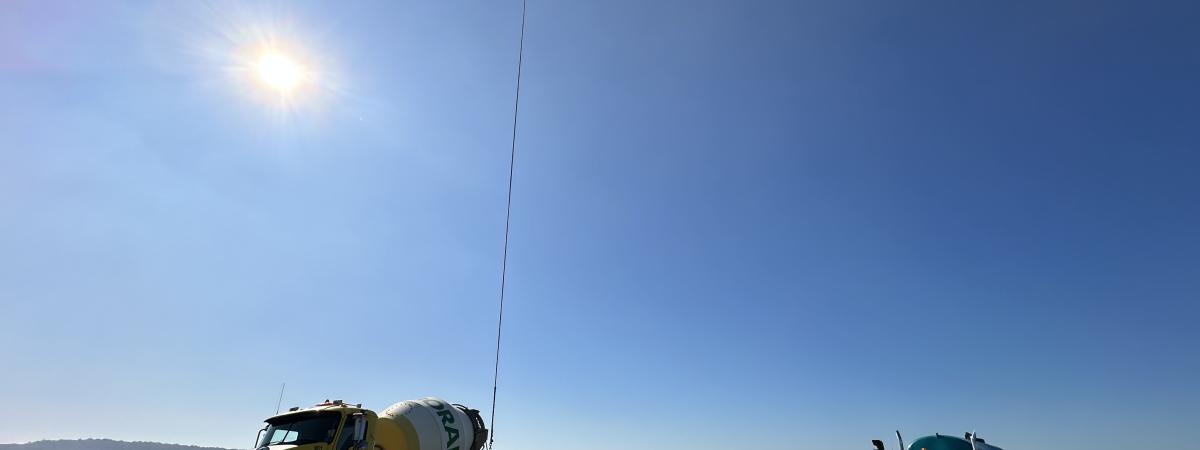 Helicopter transporting concrete in buckets