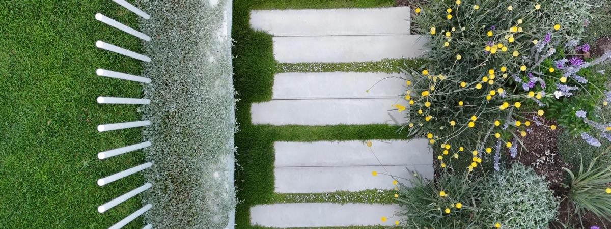 aerial view of a concrete garden path in a lush green setting