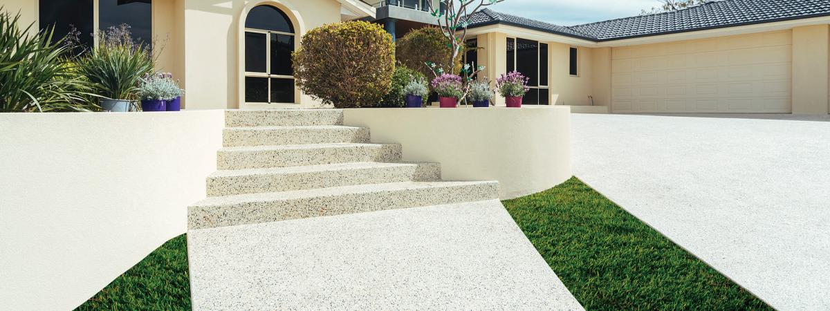 House with exposed concrete driveway