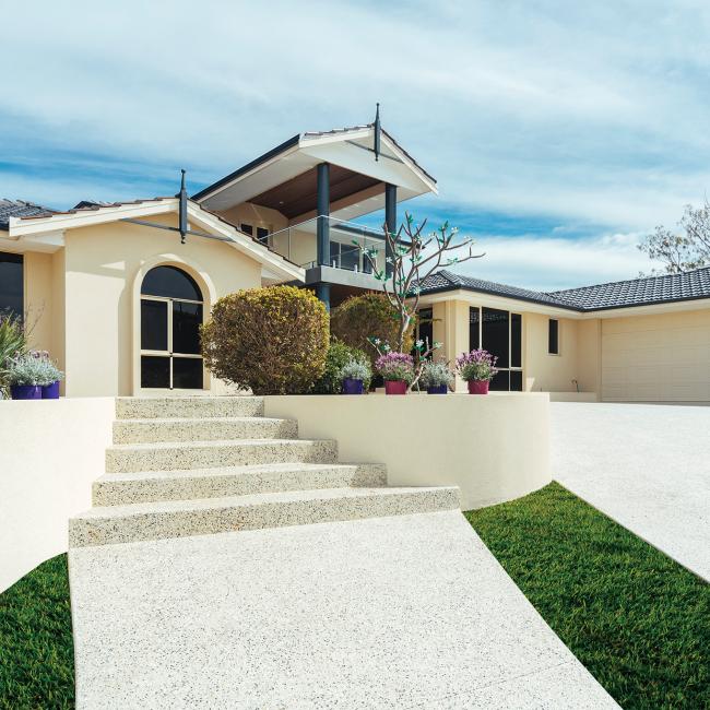 House with exposed concrete driveway
