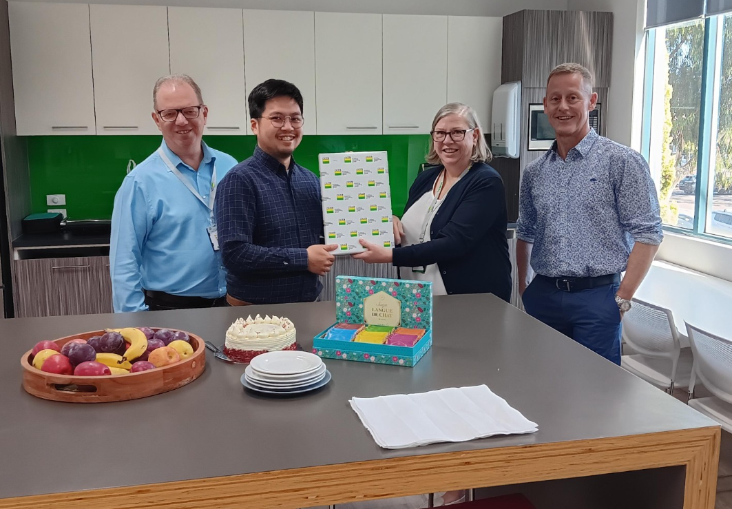 Eliza O'Day - third from left presents colleague Jeremy Foo with his service award