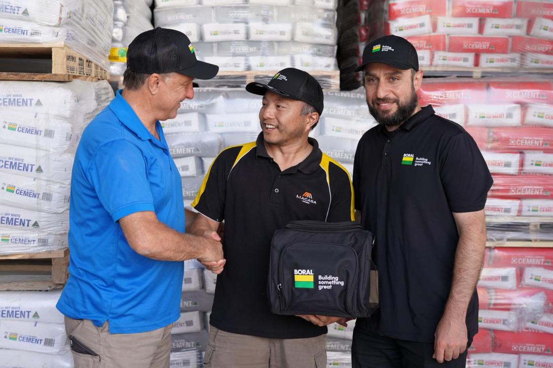 Winner F.L. Jia accepting a TEMPEST Spa prize from Boral Account Manager Ersin Teke and Seymours Building Supplies owner Justin Bucciarelli.