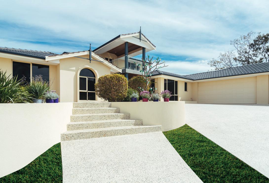 House with exposed concrete driveway